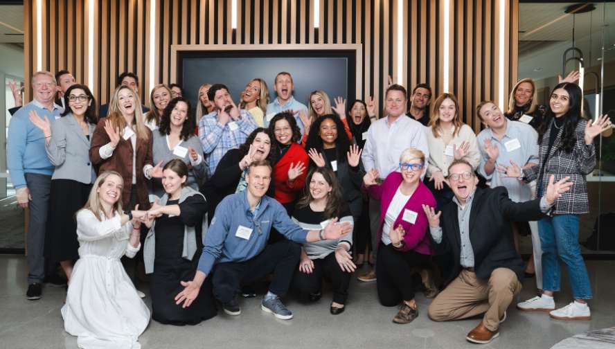 A group of people posing with hands up