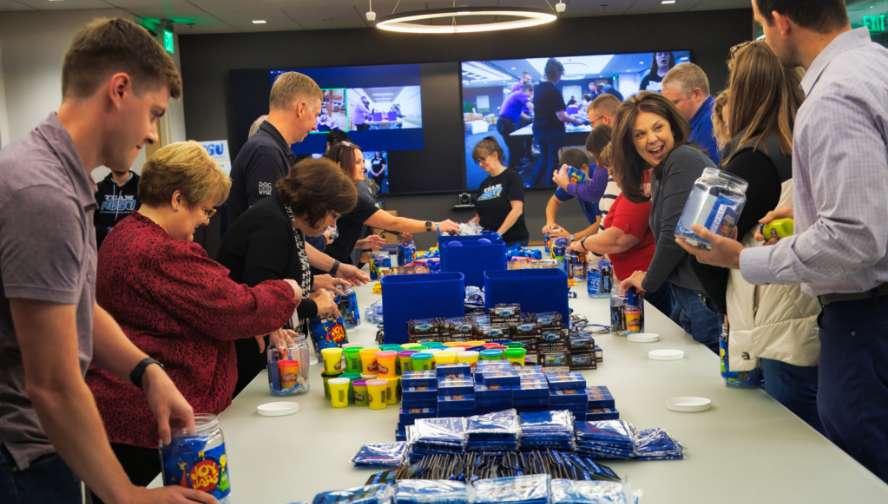 A group of people around a table packing items
