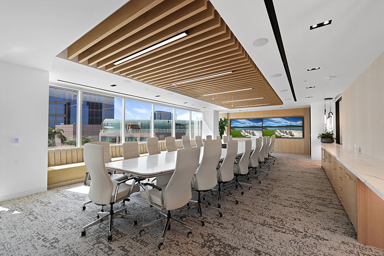 A long white conference table in an office room